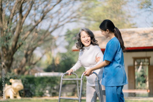 Professional physiotherapist taking care of asian senior patient during rehabilitation. © NINENII