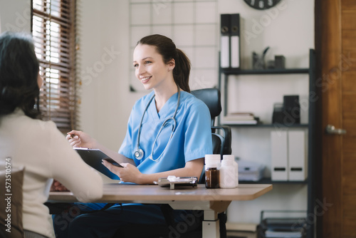 Healthcare worker attends to a senior woman in a home.