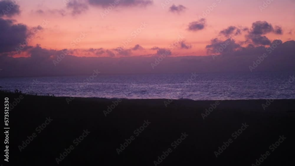 A close up shot of early morning sunrise clouds with a pink glow accross the horizon on the Australian coastline. A close up shot of early morning sunrise clouds with a pink glow accross the horizon on the Australian coastline.