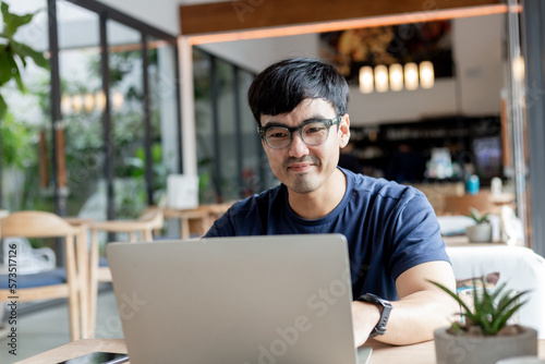 asian man work using computer hand typing laptop keyboard contact us.student study learning education online.adult professional people chatting search at office.concept for technology device business