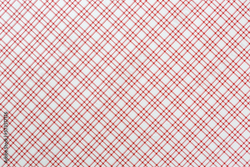 Checkered tablecloth or napkin with red stripes on a white background. Close-up