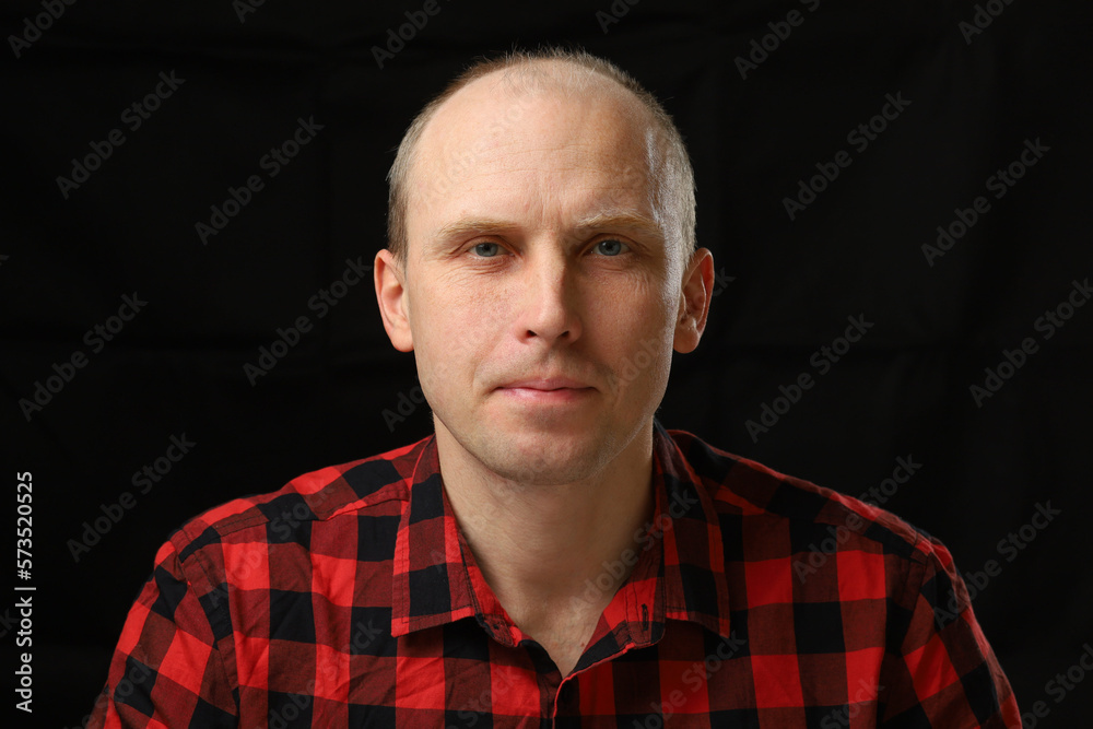 Portrait of a handsome middle-aged man in a checkered shirt Portrait of a handsome middle-aged man in a checkered shirt