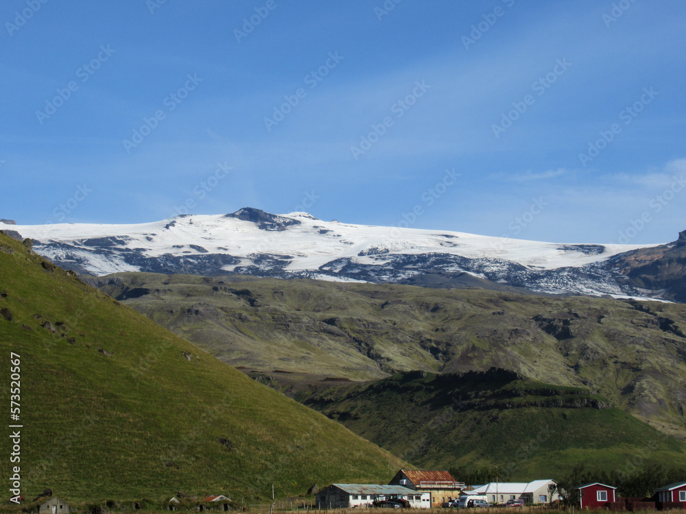 Eyjafjallajökull glacier and volcano in Iceland with small houses on foreground