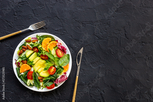 Bowl full of healthy vegetarian salad with avocado and tomatoes