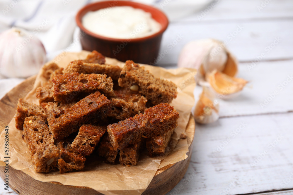 Delicious crispy rusks on white wooden table. Space for text Delicious crispy rusks on white wooden table. Space for text