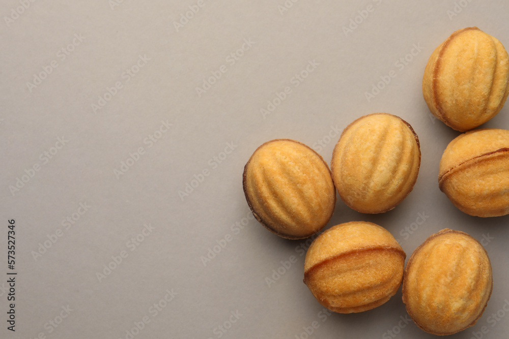 Homemade walnut shaped cookies with condensed milk on light grey background, flat lay. Space for text Homemade walnut shaped cookies with condensed milk on light grey background, flat lay. Space for text