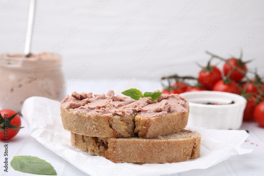 Delicious liverwurst sandwich with basil on white table