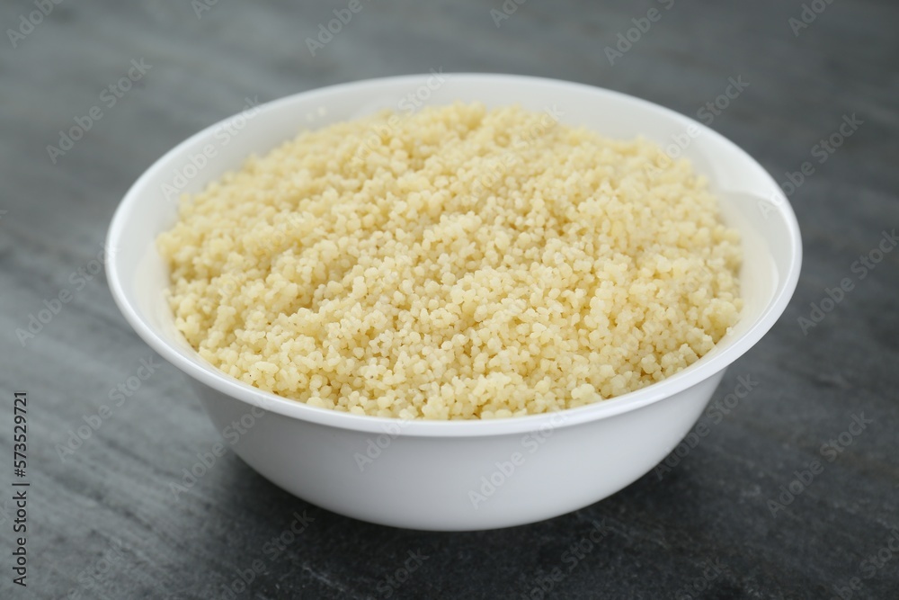 Bowl of tasty couscous on grey table, closeup Bowl of tasty couscous on grey table, closeup