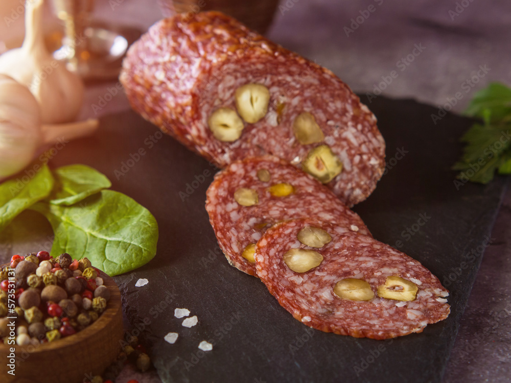 Sliced sausage with olives, on a cutting board