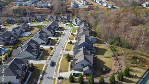 Row of new developments houses in master planned subdivision with lush green trees and natural trails outside Atlanta, Georgia, USA photo