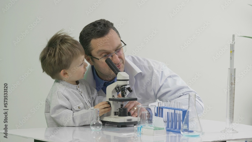 Father and son using a microscope in the laboratory Stock Photo Adobe