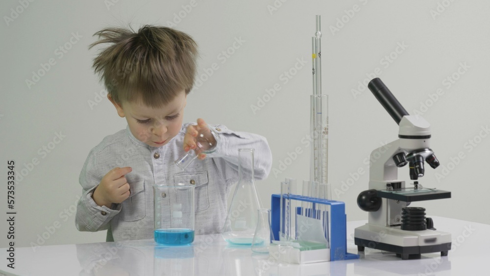 Little student working with substances in the chemistry lab Little student working with substances in the chemistry lab