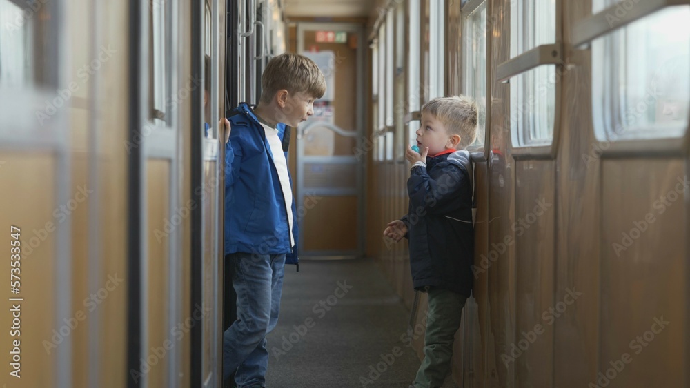 Brothers playing and running on train corridor during travelling Brothers playing and running on train corridor during travelling
