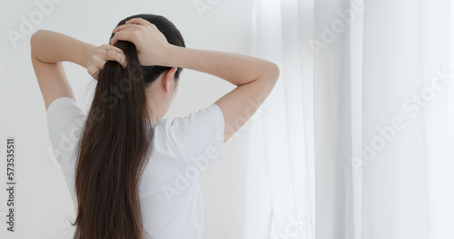 woman tying her long hair