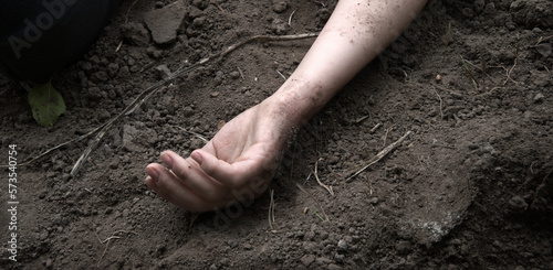 Fotografiet Hand of a wounded soldier on the ground