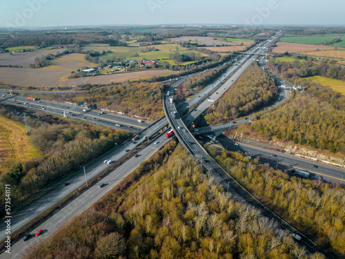 Vehicles Driving Along a Busy Motorway Interchange in the UK Aerial View