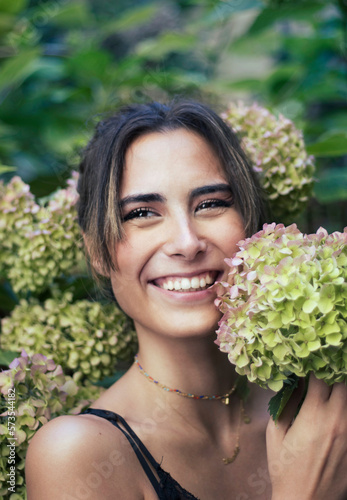 Young European woman smiling with ortensia flowers photo