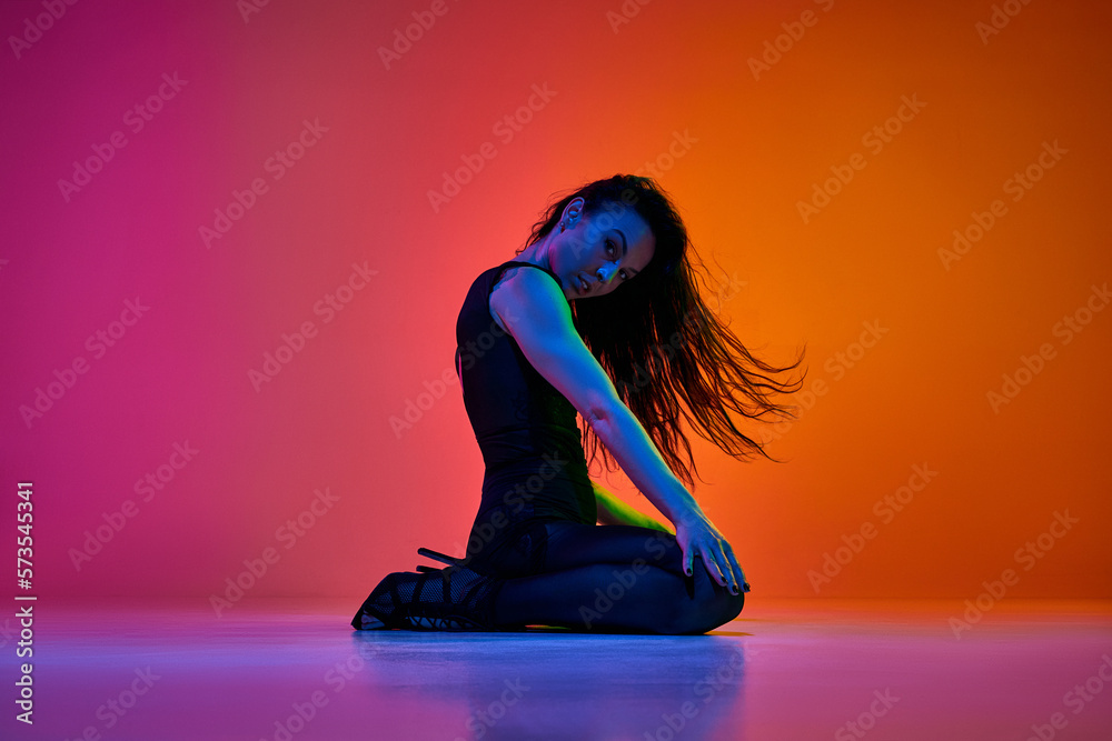 Expressive dance. Young woman, stiletto dancer performing over gradient