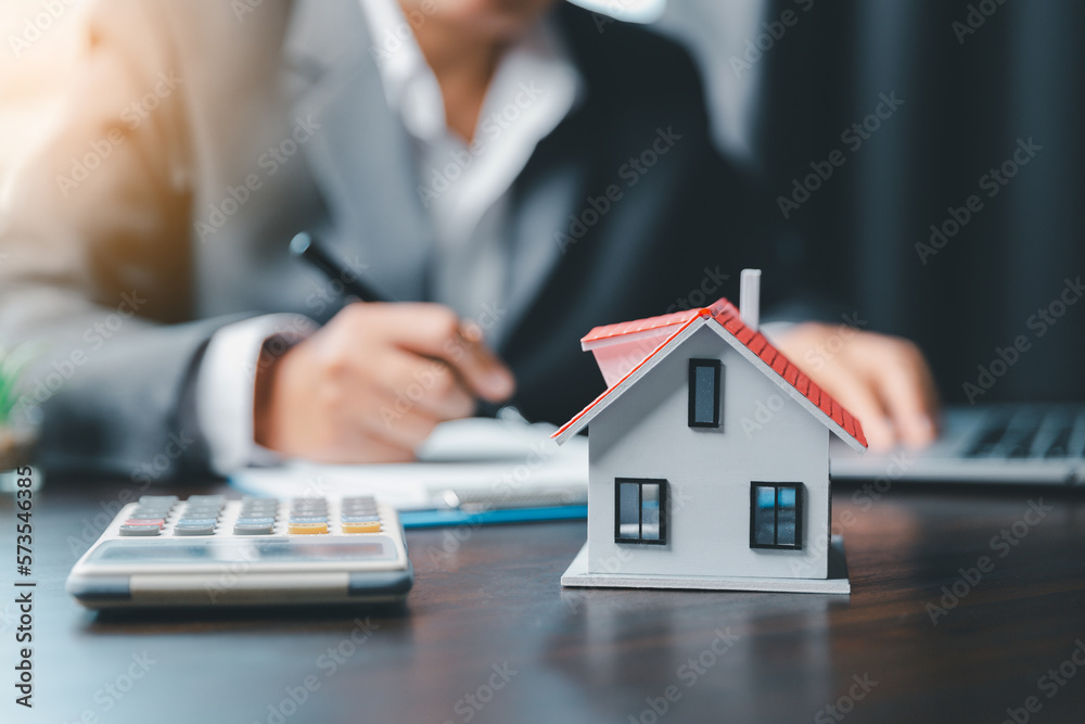 Business woman or lawyer accountant working financial investment on office. insurance protective hand over house for protection and care, Concept of home and real estate Property insurance. - obrazy, fototapety, plakaty 