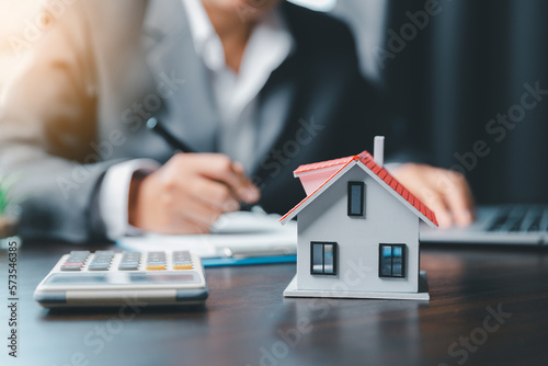 Business woman or lawyer accountant working financial investment on office. insurance protective hand over house for protection and care, Concept of home and real estate Property insurance.