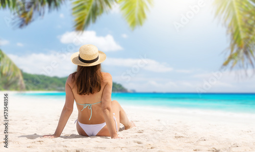 Woman sitting on the sea beach