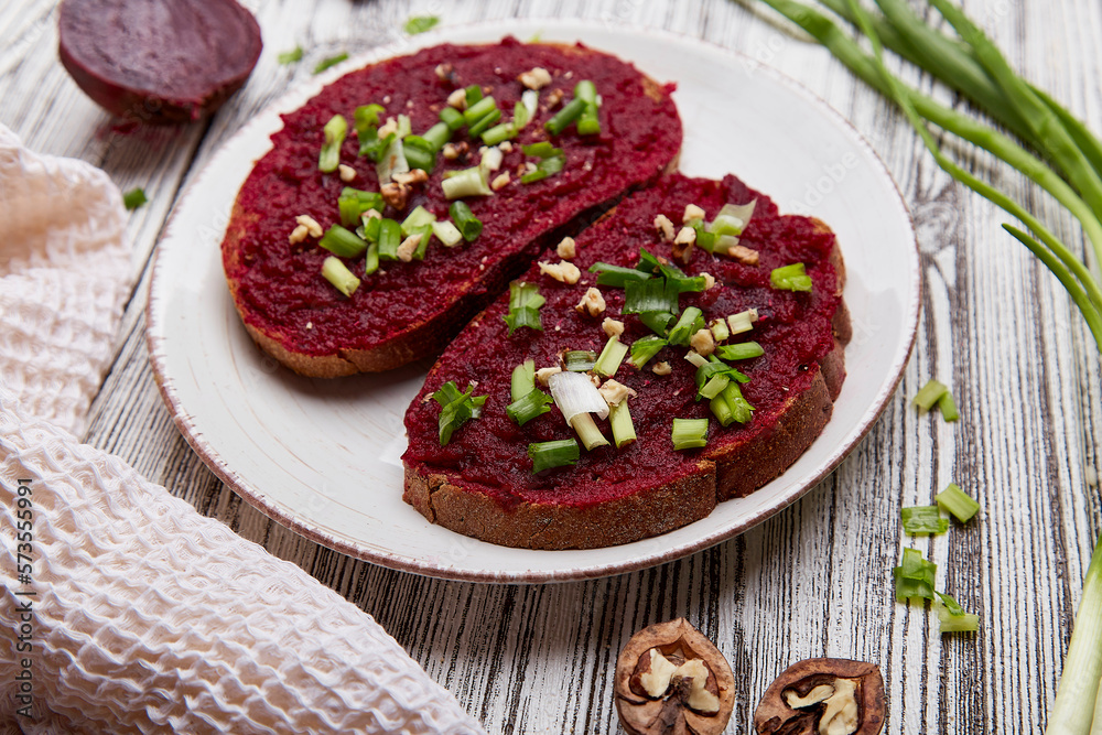 Beetroot spread with spring young onion and walnuts sandwiches. Vegetarian food close up Beetroot spread with spring young onion and walnuts sandwiches. Vegetarian food close up