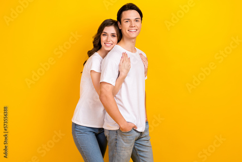 Photo of pretty cute husband wife dressed white t-shirts hugging smiling isolated yellow color background