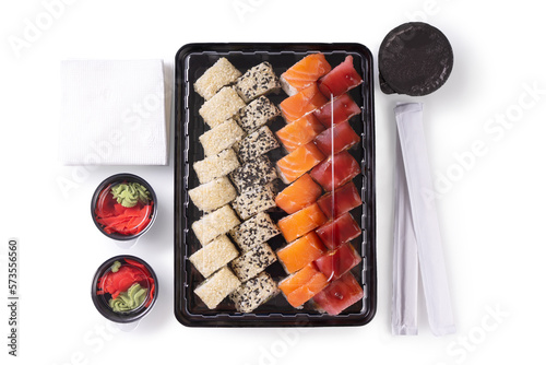 Sushi set with wasabi  ginger and soy sauce served in plastic box takeaway  to go. Assorted of Japanese sushi with tuna  salmon  sesame isolated on white background. Top view  flat lay  wallpaper