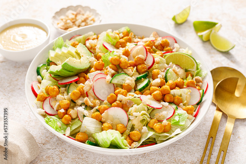 Canvastavla Healthy spring vegan Caesar salad with chickpea, fresh cucumber, radish, avocado and crispy croutons, dressed with garlic sauce