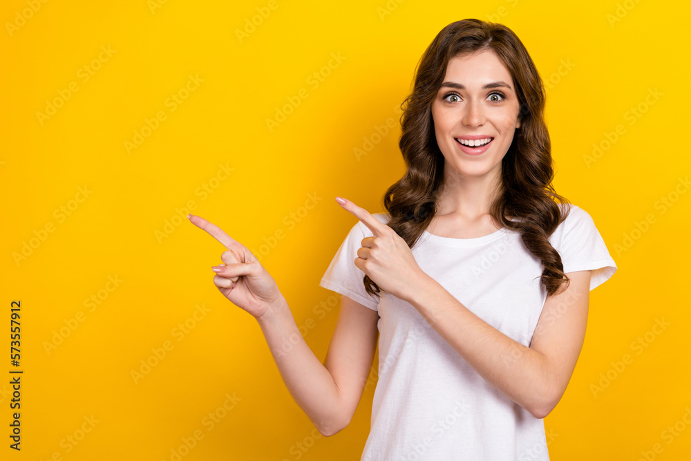 Photo of surprised young business woman white t-shirt unexpected directing fingers mockup announce free promo isolated on yellow color background Photo of surprised young business woman white t-shirt unexpected directing fingers mockup announce free promo isolated on yellow color background