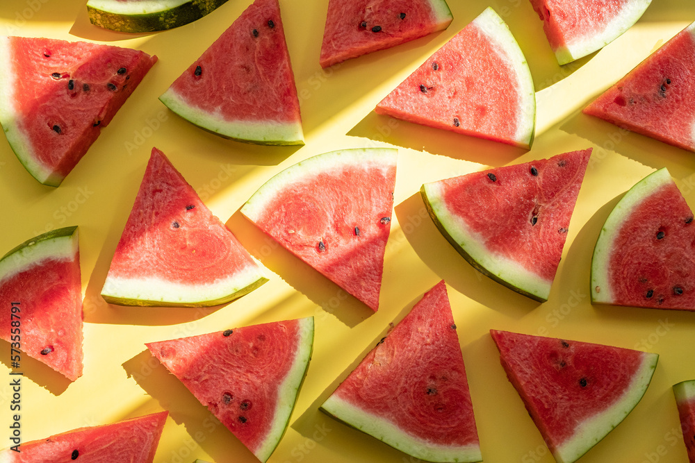 Watermelon pattern. Sliced watermelon on yellow background, top view Watermelon pattern. Sliced watermelon on yellow background, top view