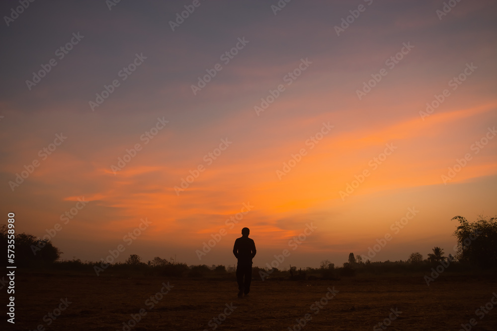 Silhouette man standing in the sunset.