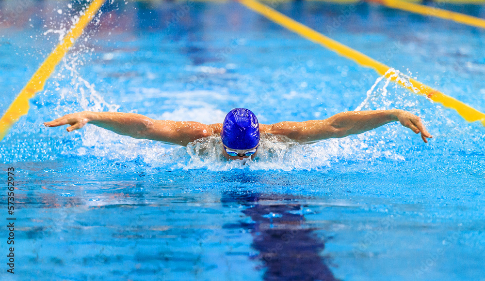 man athlete swimming butterfly stroke in competition race
