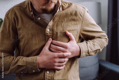 фотографія Male having cardiac medical health problem painful sickness symptoms myocardial infarction