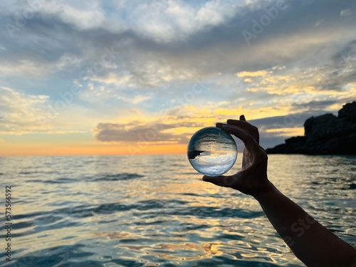 Fotografie Beautiful scenic view through lens of crystal ball at summer sunset