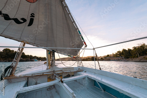 Felucca Sailing on the Nile River in Aswan. Popular Tourist Sailboat in the Nile. Aswan, Egypt. Africa.
