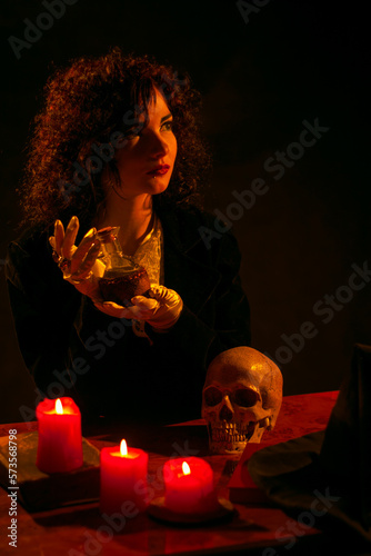 Young witch with potion photo