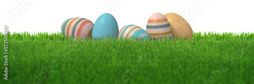 Colorful stripes decorated easter eggs in natural green spring grass lawn isolated