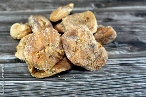 Dried figs fruit that is used in Ramadan Khoshaf or compote with dried dates fruit and apricot paste that Muslims start their breakfast in Ramadan on it, selective focus of Ramadan food background photo