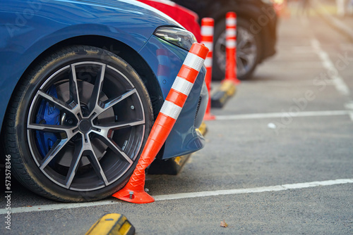 Car bent polyurethane flexible post while parking on crowded parking lot in downtown. Car damaged flexible bollard in parking stalls. Car hit bollard at parking lot, damaged driver side bumper photo