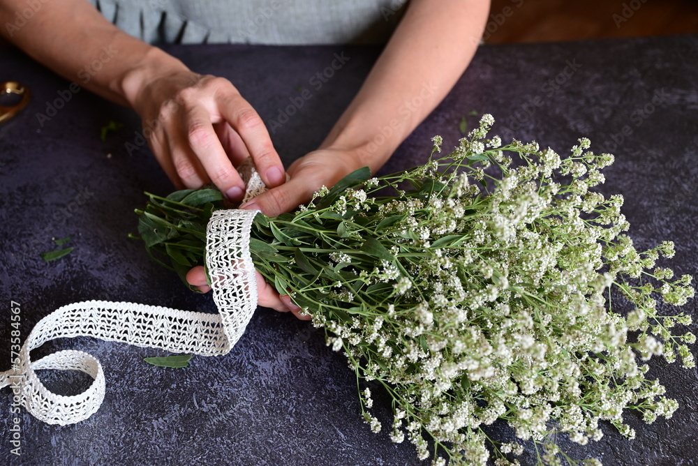 Florist at work. How to make gypsophila paniculata wedding wreath, step