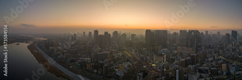 Panoramic aerial view of Yodo River and downtown Osaka before sunrise on misty morning