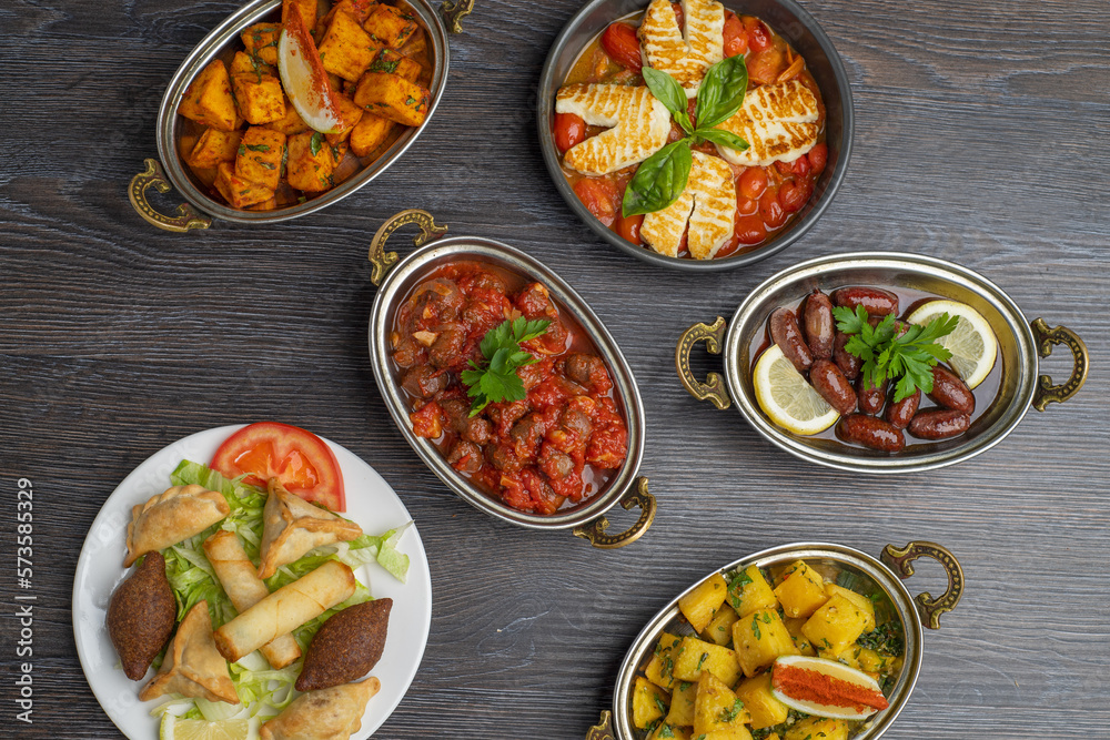 Set of Lebanese mezze of Spicy potatoes, potato cubes, cheese rolls