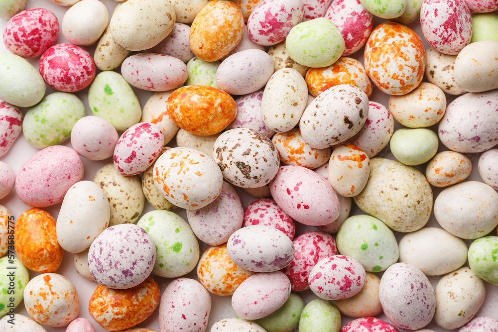 Easter background made of multicolored candy chocolate eggs. Overhead view, close up. Festive food background. Holiday symbol Easter background made of multicolored candy chocolate eggs. Overhead view, close up. Festive food background. Holiday symbol