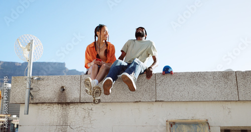 Konstfotografi Love, friendship and a couple sitting on rooftop of city building in summer time