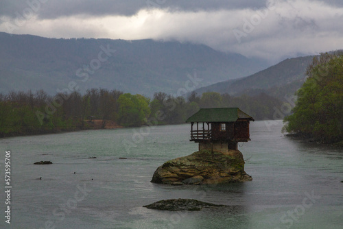 Lonely house on the river Drina in Bajina Basta, Serbia. Dramatic atmosphere photo
