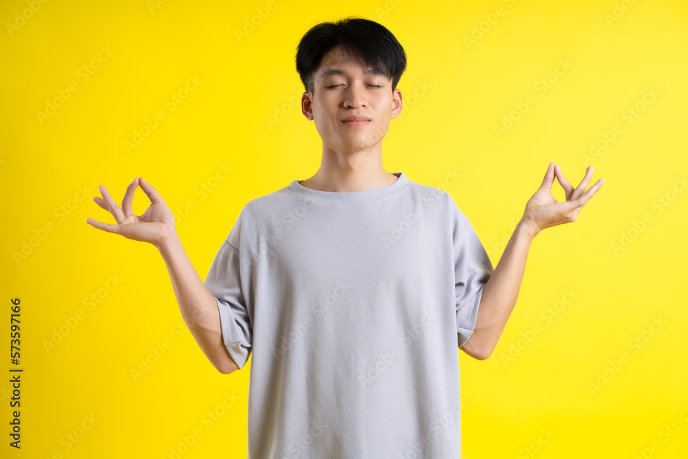 image of handsome young man posing on a yellow background image of handsome young man posing on a yellow background