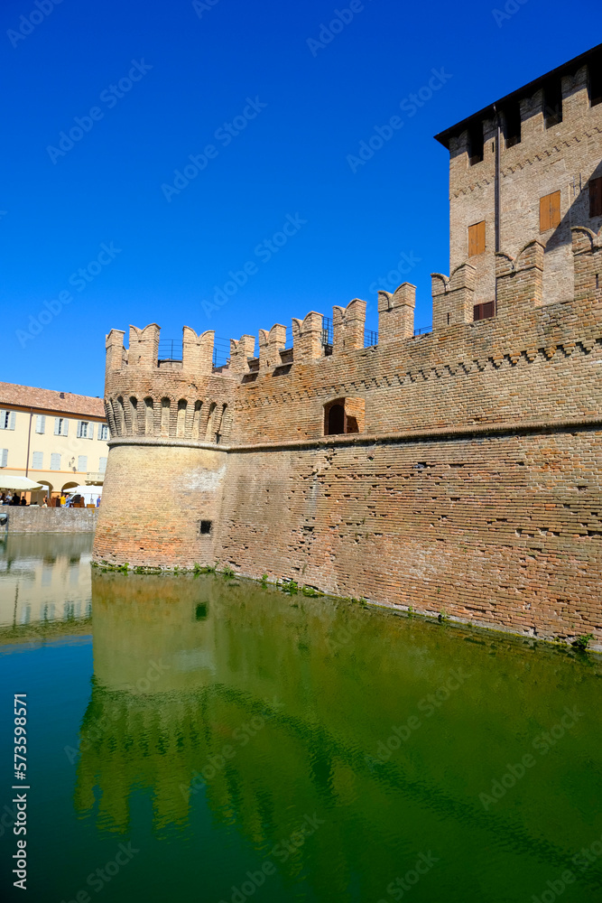 Fontanellato, Parma: the building of the castle La Rocca Sanvitale across the lake on a market day