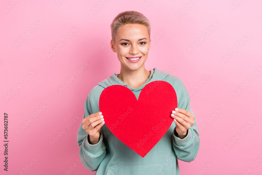 Photo portrait of pretty young girl hold red heart postcard feelings love wear trendy khaki clothes isolated on pink color background Photo portrait of pretty young girl hold red heart postcard feelings love wear trendy khaki clothes isolated on pink color background