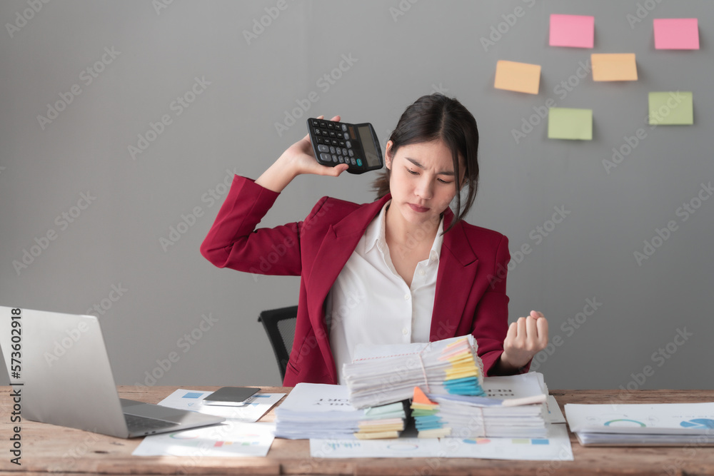 Hard working of asian people bookkeepers working with balance sheet and taxation, company quarterly reports of accounting and marketing. stressed, headache Hard working of asian people bookkeepers working with balance sheet and taxation, company quarterly reports of accounting and marketing. stressed, headache